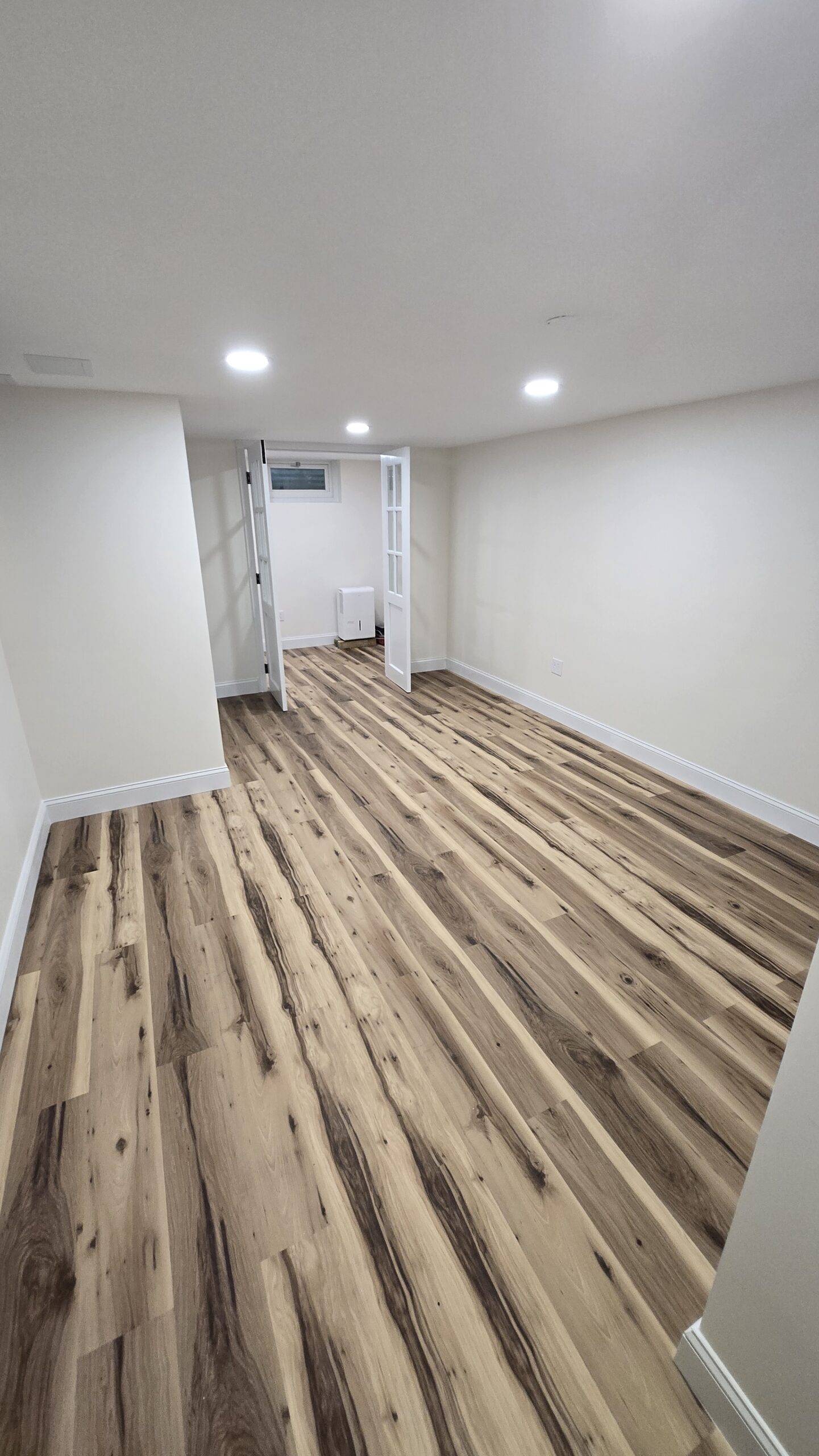 Hallway and entry renovation with updated flooring and lighting