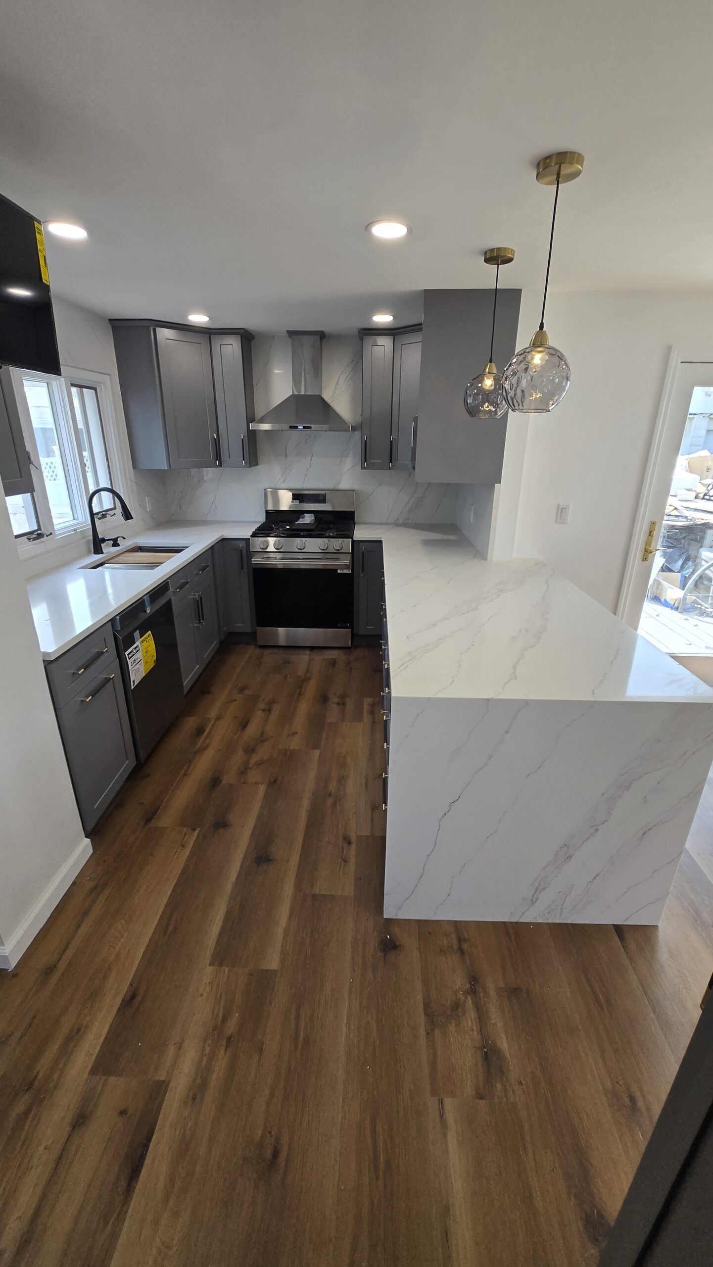 Bright kitchen renovation with wood floors and modern finishes